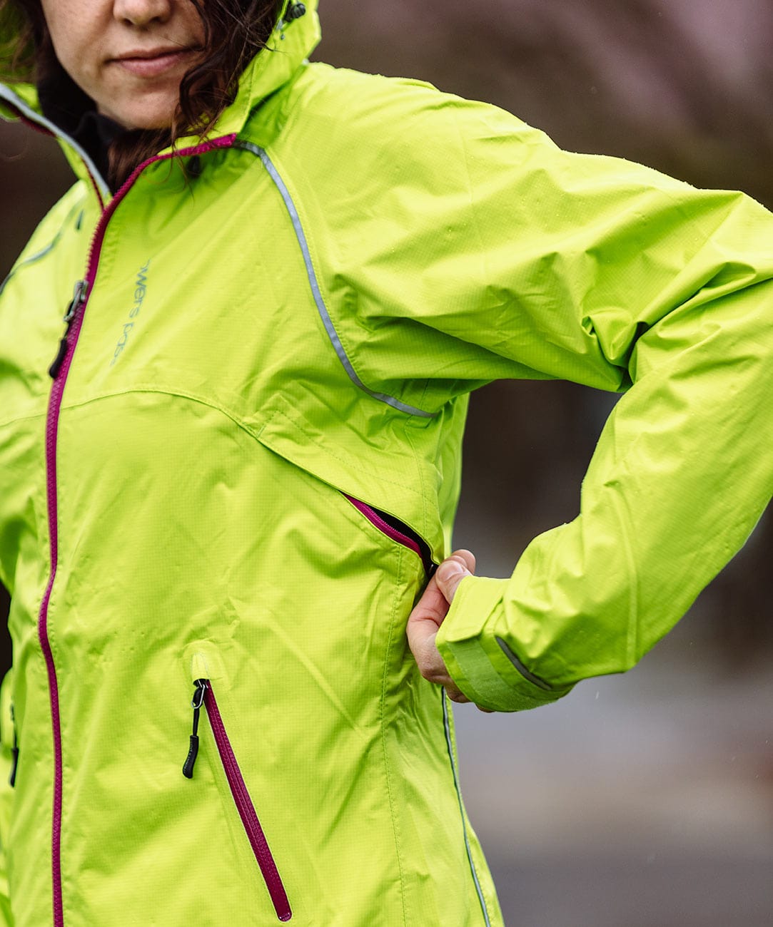 Women's Syncline CC Jacket, hi-vis yellow, side view on a rider