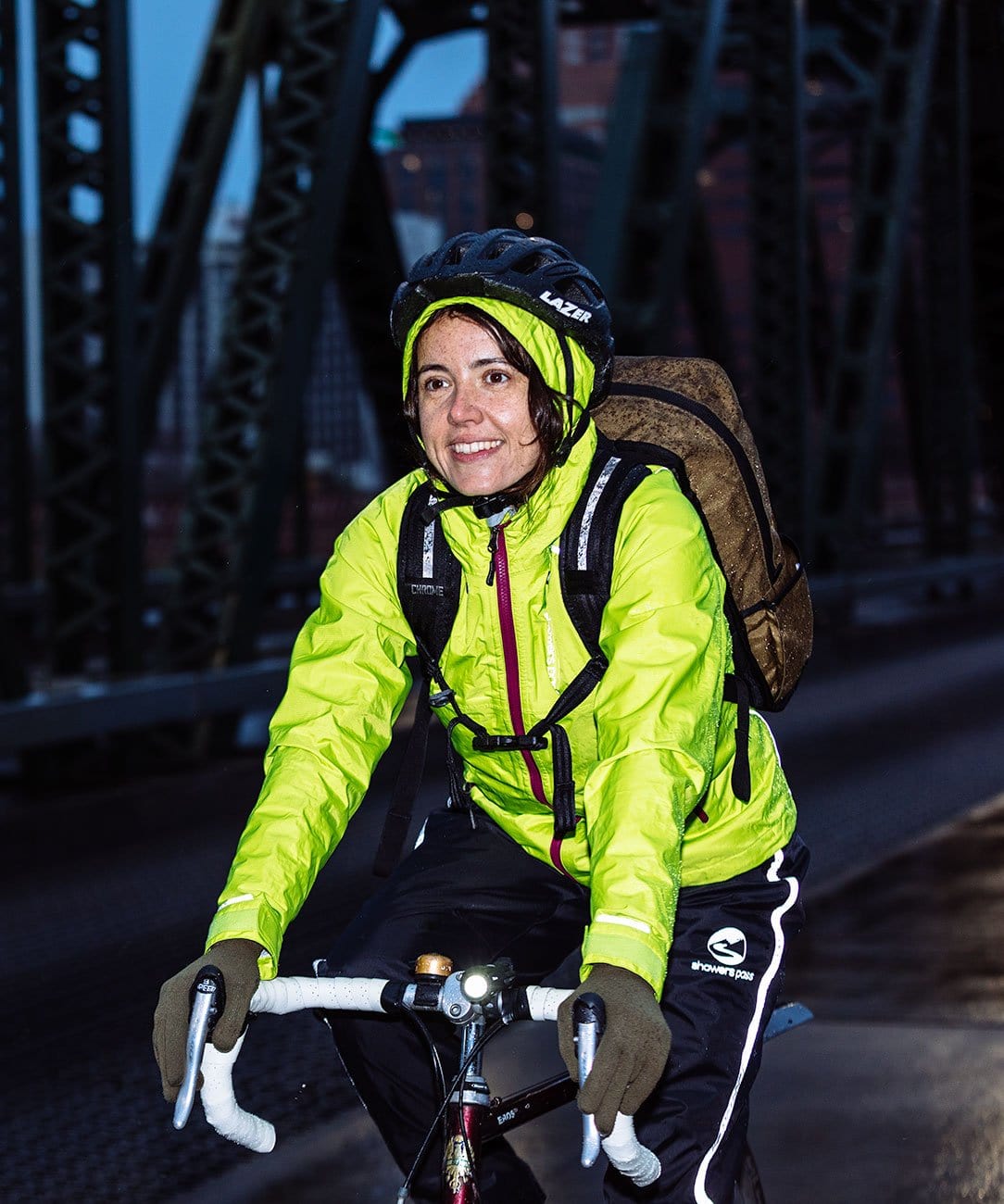 Women's Transit Pant, worn by a rider on a bridge with a hi-vis jacket