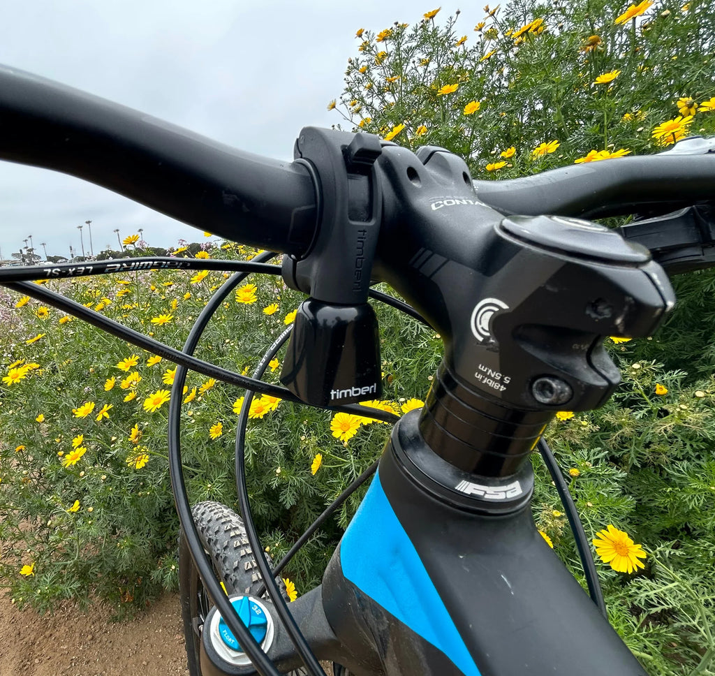 Timber Model Yew! Bolt-on Trail Bell, mounted on a mountain bike handlebar on the trail