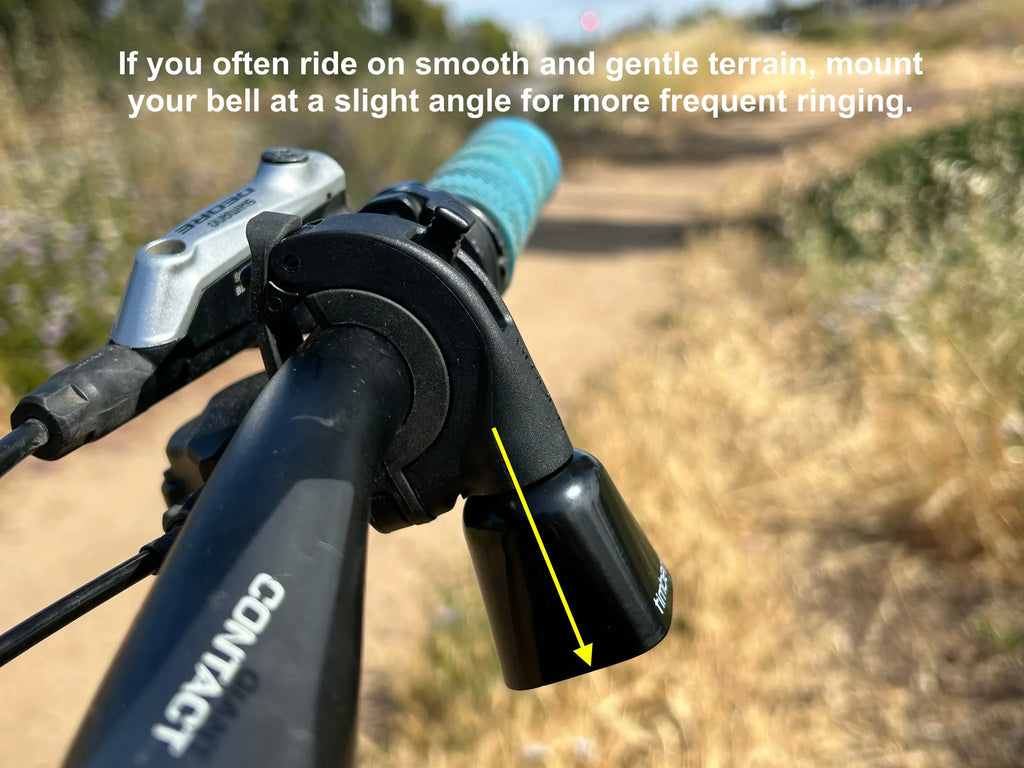 Timber Model Yew! Quick Release Trail Bell, mounted at an angle on the handlebar, with a tip for smooth terrain