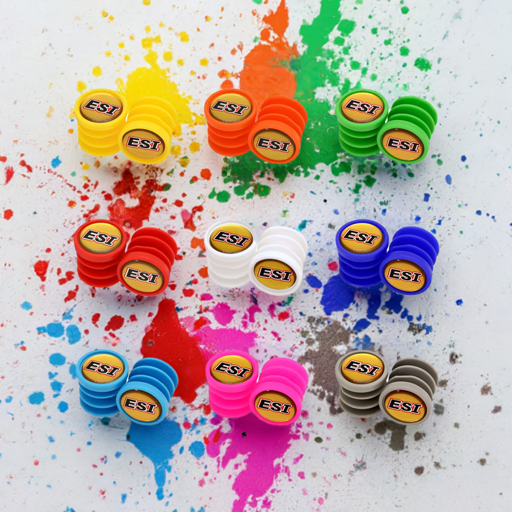 ESI bar plugs scattered on white in orange, green, blue, purple, red and yellow