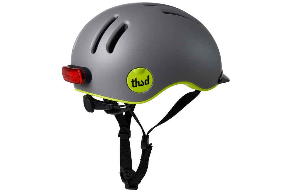 Chapter MIPS Helmet, gray with neon yellow trim, rear angle with straps and light