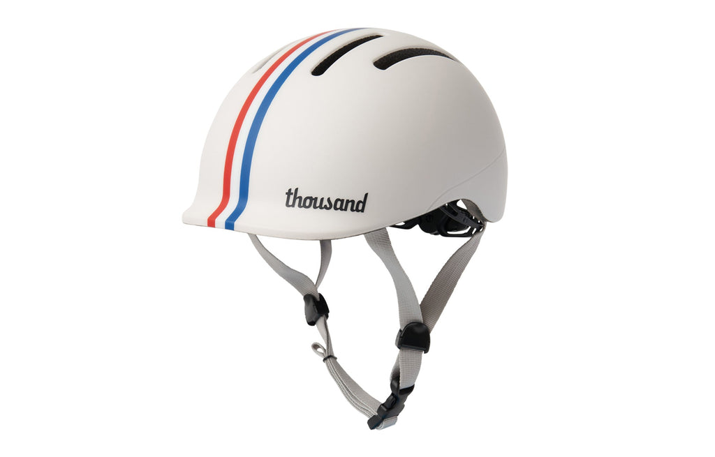 Thousand Jr. Toddler Helmet, white with red and blue stripes, side view with straps