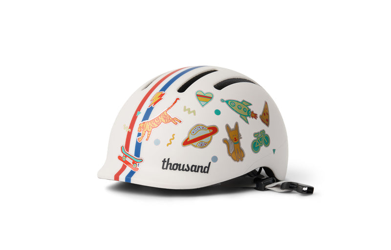 Thousand Jr. Toddler Helmet, white with red and blue stripes, decorated with stickers